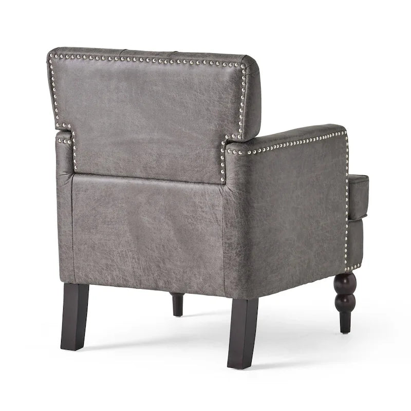 Poltrona club color ardesia con 28 bottoni capitonné e borchie decorative